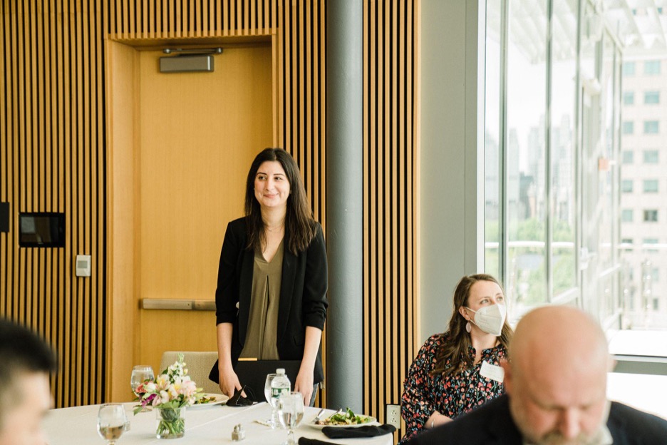 Basima Tewfik standing and smiling as she receives an award.