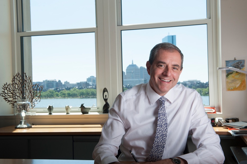 David Autor smiling, sitting in an office.