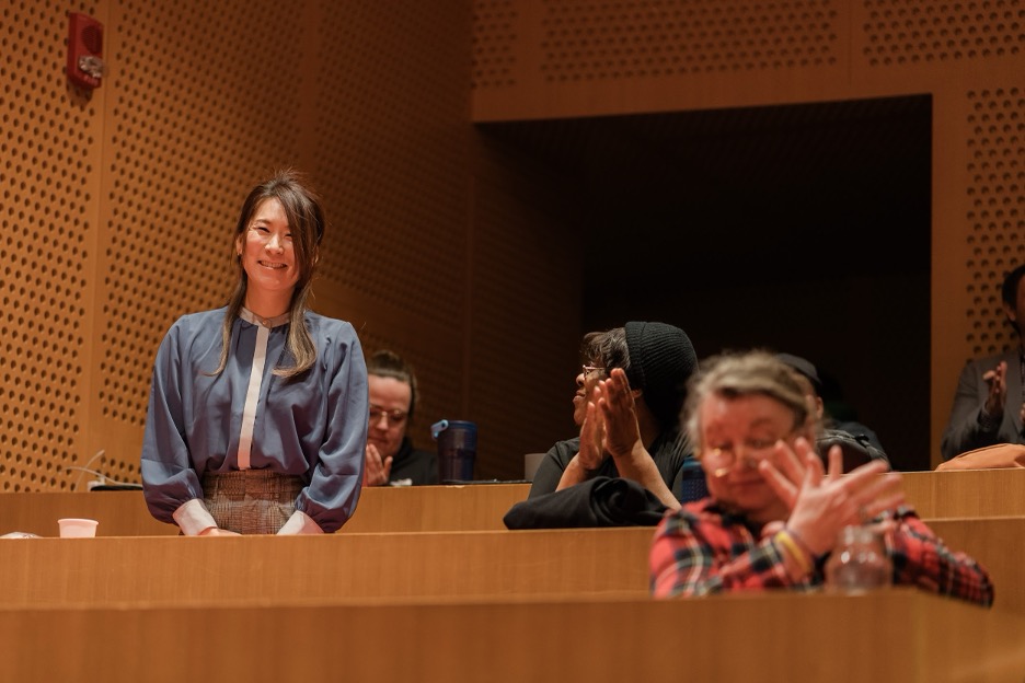 Wakana Maekawa smiling as event attendees give her a round of applause.