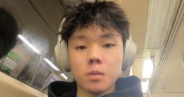 Headshot photo of a teenager wearing headphones.