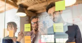 people writing on a board