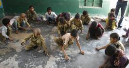 children writing with chalk 