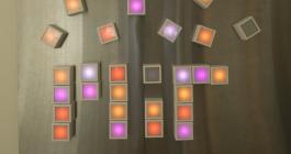 Photo of light blocks arranged to spell "MIT" on a table.