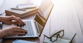 person typing on a laptop