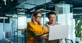 two people looking at a laptop