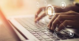 Hands typing on a locked laptop keyboard