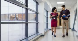 two professionals walking down the hall