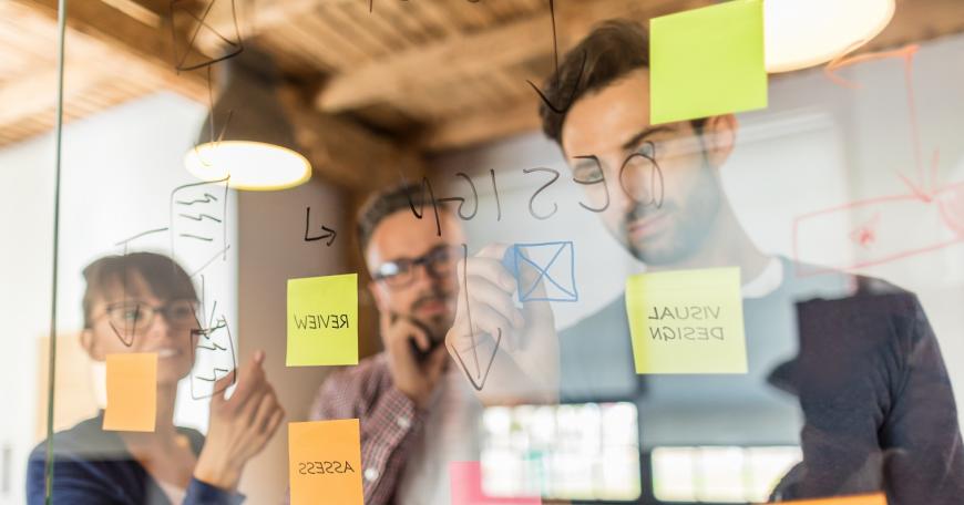 people writing on a board