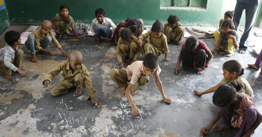 children writing with chalk 