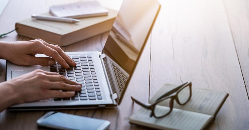 person typing on a laptop