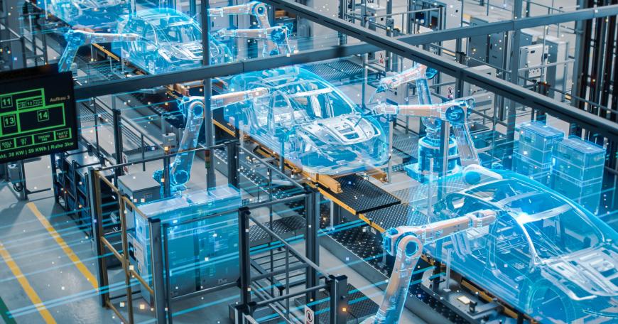 Photo of a car factory with a digital simulation of an assembly line of automated robot arms superimposed over the factory.