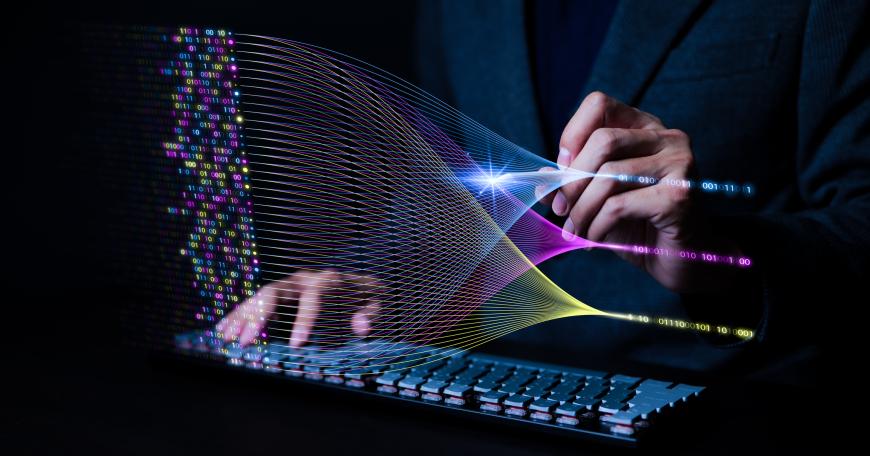 Photo of hands behind a keyboard with illustration of a generative artificial intelligence large language model above.