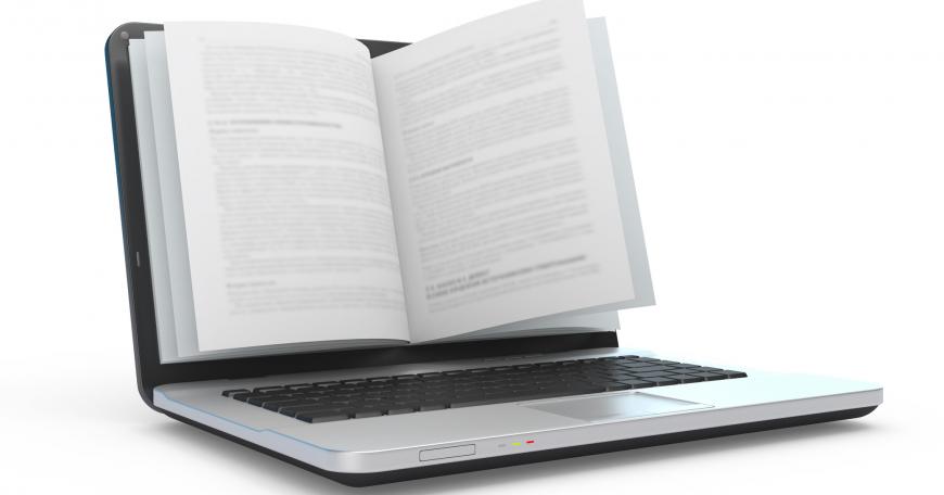 Laptop with book pages on the screen