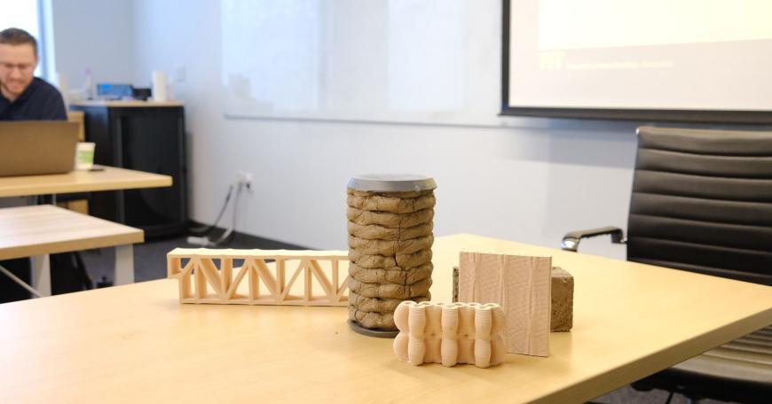 Photo of a table with four wooden structures sitting on top.