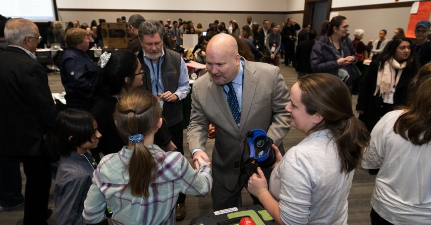 man shaking hands at the LearnLaunch Convention