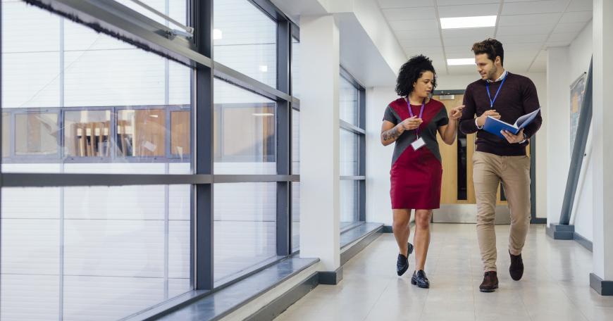 two professionals walking down the hall