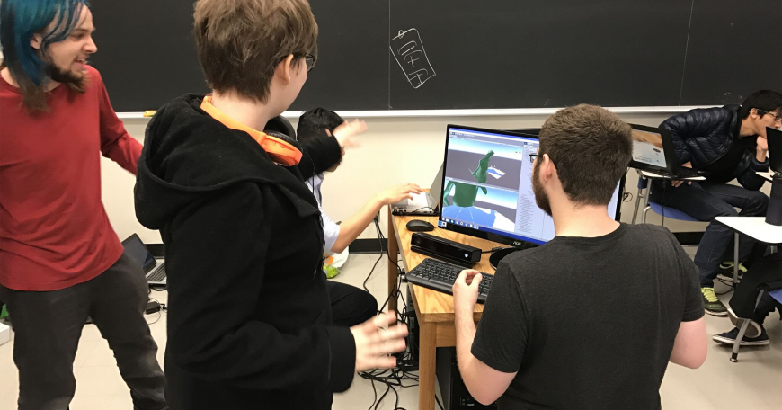 MIT undergraduate Mark Vrablic (standing, left) engages as the teaching assistant and mentor for a student group building a video game in a nine-day workshop that he helped design and publish on MIT’s OpenCourseWare along with Department of Materials Science and Engineering lecturer Kyle Keane and Andrew Ringler from the Interactive Materials Education Laboratory.
