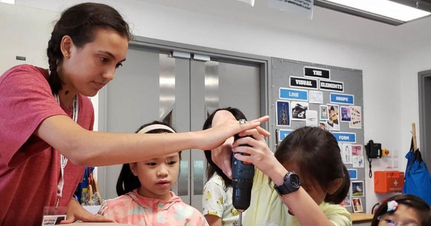 Young learners at the Chinese International School build their own project with guidance from rising MIT junior Rana Odabas.