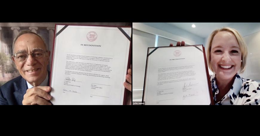 MIT President L. Rafael Reif and Accenture CEO Julie Sweet present signing documents to the screen in a virtual signing ceremony.
