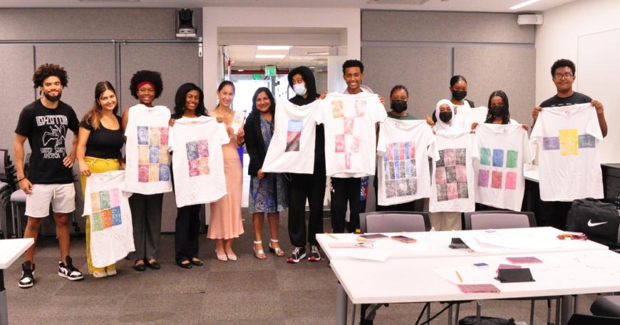 Cambridge Mayor Sumbul Siddiqui visits the Mayor's Summer Youth Employment Program (MSYEP) learning site at MIT while students worked on T-shirts that imagined how data science could be used to support marginalized communities. Left to right: Yusuf Solomon, Zeynep Yalcin, Olivia Dias, Raechel Walker, Cynthia Breazeal, Siddiqui, Jacob G., Jacob T., Lisa, Jesmin, Nina, Kiki, and Neko.