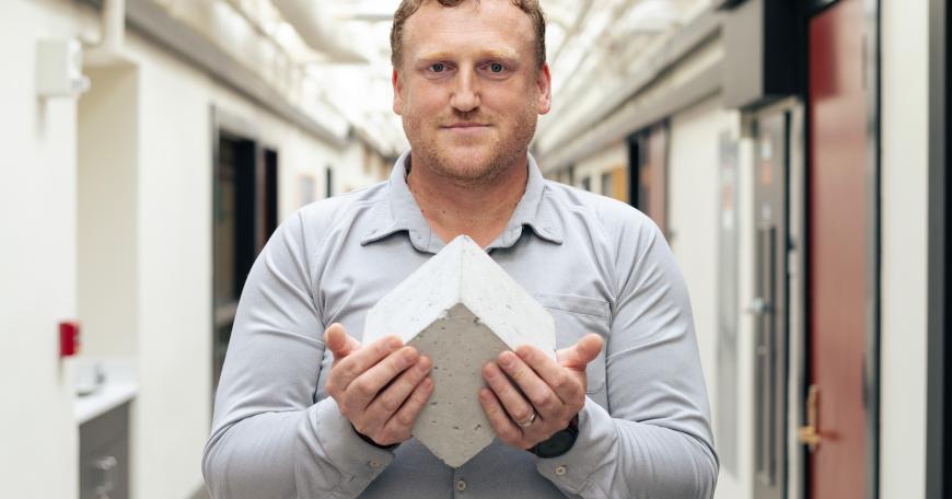 “Roman concrete to me is fascinating: It’s still standing after all this time and constantly repairing,” Admir Masic says, pictured here holding a Roman-inspired, self-healing concrete cube. 