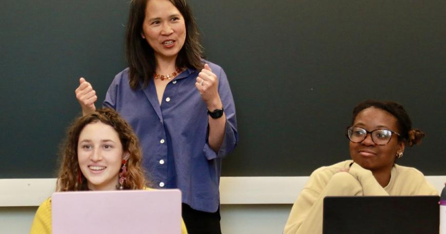 Professor Lily Tsai (standing), in class with teaching assistant Leela Fredlund (left) and student Karenna Caton.