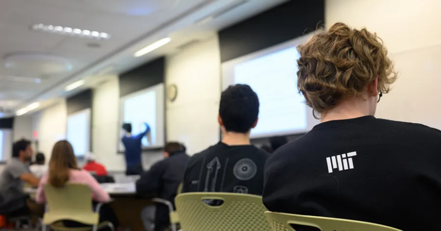Groups of students in a college lecture hall.