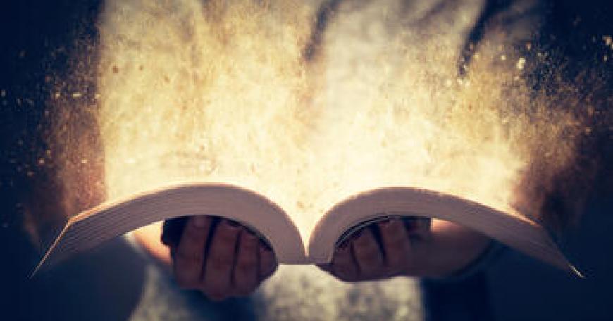 Closeup up of a person holding an open book