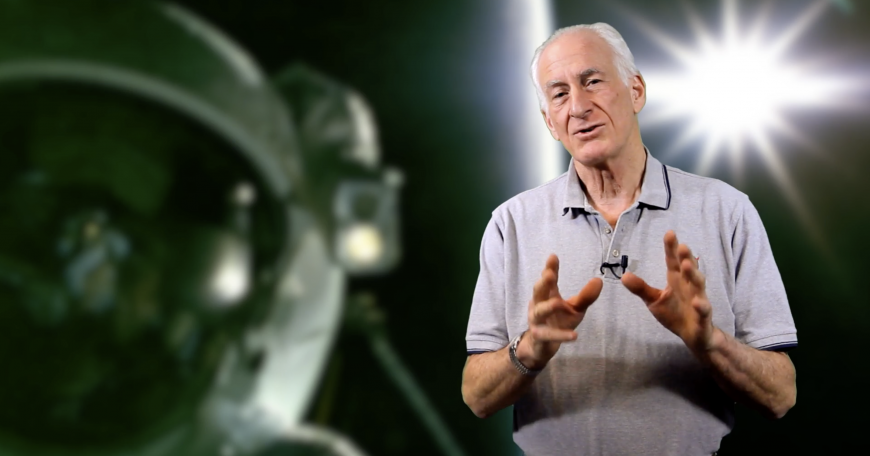 Prof. Jeff Hoffman lecturing in an MITx video, spacewalk graphic in background