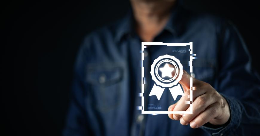 Hand holding a glowing digital badge or certificate icon