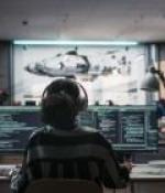 woman staring at a screen with headphones 