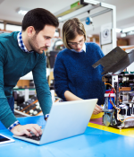 two people looking at a computer 