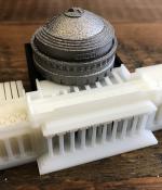 A new online course from MIT and Boeing uses a 3-D-printed kit to enrich the learning experience. Similar to a textbook, the kit is used as a reference throughout the course. The kit has metal and polymer parts made by industry-relevant 3-D-printing processes, including stereolithography, multi-jet fusion, and direct metal laser sintering. The parts interlock to form a model of MIT's iconic Building 10 dome.