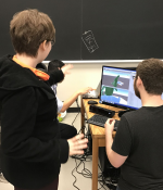 MIT undergraduate Mark Vrablic (standing, left) engages as the teaching assistant and mentor for a student group building a video game in a nine-day workshop that he helped design and publish on MIT’s OpenCourseWare along with Department of Materials Science and Engineering lecturer Kyle Keane and Andrew Ringler from the Interactive Materials Education Laboratory.