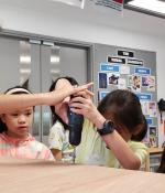 Young learners at the Chinese International School build their own project with guidance from rising MIT junior Rana Odabas.