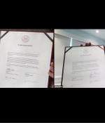 MIT President L. Rafael Reif and Accenture CEO Julie Sweet present signing documents to the screen in a virtual signing ceremony.