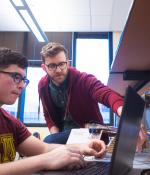 Senior lecturer Joe Steinmeyer (standing) assists a student in 6.08, (Introduction to EECS via Interconnected Embedded Systems). 