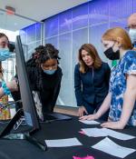 Three students from Mary Lyon School in Boston share their project with Lieutenant Governor Karyn Polito and Vertex Executive Chairman Jeffrey Leiden.