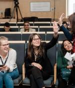 MIT Bootcamps coach Suzanne Mitchell (standing at right) celebrates with learners.