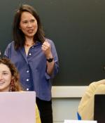 Professor Lily Tsai (standing), in class with teaching assistant Leela Fredlund (left) and student Karenna Caton.