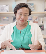Paula Hammond, seated, speaking to the camera at her desk
