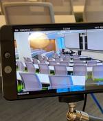 Photo of a camera screen displaying a lecture hall.