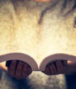 Closeup up of a person holding an open book