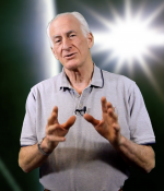 Prof. Jeff Hoffman lecturing in an MITx video, spacewalk graphic in background