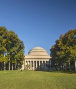 MIT great dome surrounded by trees with Killian court in the foreground