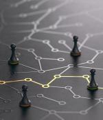 Photo of pawn chess pieces on a table with drawings of lines connecting nodes.