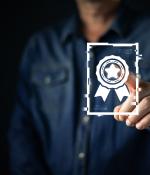 Hand holding a glowing digital badge or certificate icon